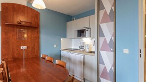 A compact kitchen with a microwave, coffee maker, and dishwasher. - Pleasant duplex, parking - 7 guests (La Mongie)