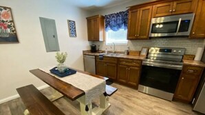 A kitchen with wooden cabinets, a stainless steel oven, and a microwave.