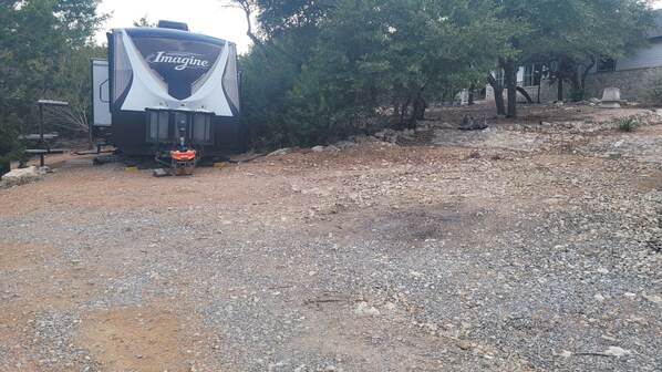 A recreational vehicle (RV) with the brand 'Imagine' parked on a gravel surface. - Updated ! Luxury Lake Travis RV (Spicewood)