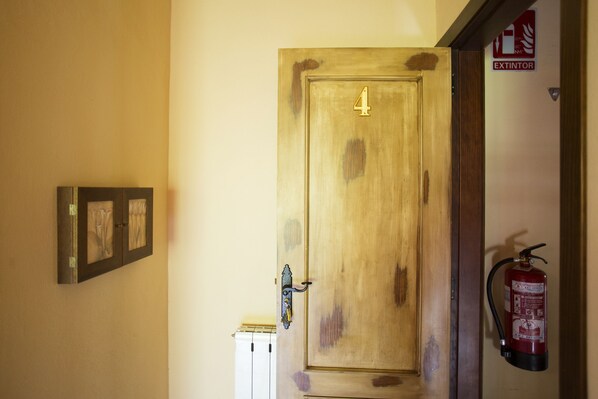 Room 4 features a fire extinguisher for added safety and a decorative framed picture.