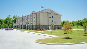 Stunning hotel with a symmetrical facade, landscaped yard, and ample parking.