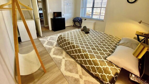 A bedroom with a bed, a ceiling fan, a window, and a door. - Easy Walk to Downtown Attractions & WORLD CUP! (Atlanta)