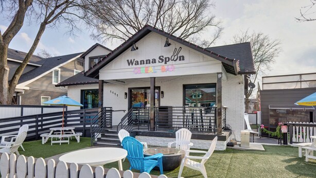 A Cereal Bar named 'Wanna Spn' with outdoor seating and a fire pit.