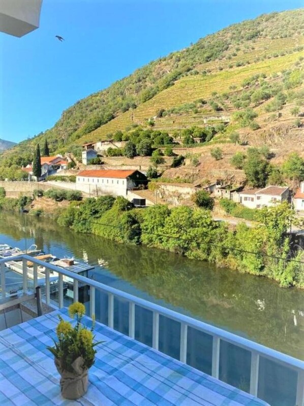 A riverside view with buildings and greenery.
