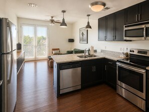 A modern kitchen with stainless steel appliances, a dishwasher, and a double oven.