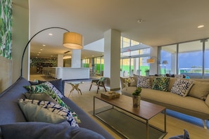 Relax in this inviting living area with a comfortable sofa, sleek coffee table, and contemporary lamp.