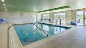 An indoor swimming pool with clear water, surrounded by tiled walls and a green ceiling. - Holiday Inn Express & Suites Abingdon by IHG (Abingdon)