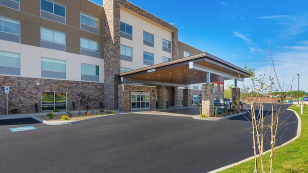 A modern building with a stone facade, large windows, and a covered entrance area. - Holiday Inn Express & Suites Abingdon by IHG (Abingdon)