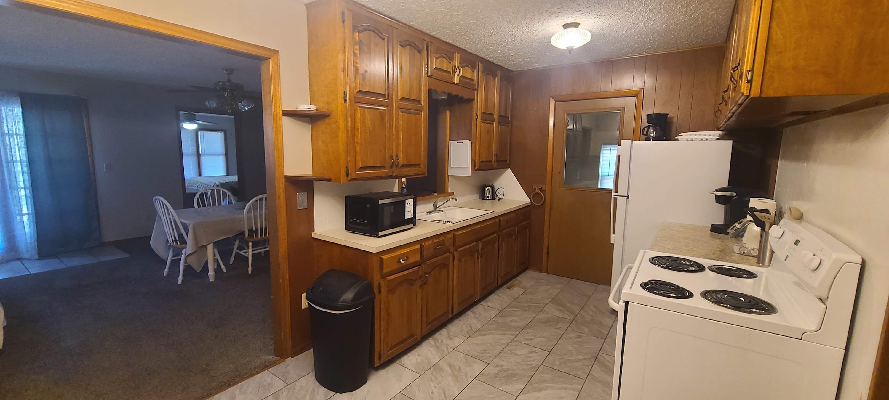 Fridge, microwave, coffee/tea maker, cookware/dishes/utensils