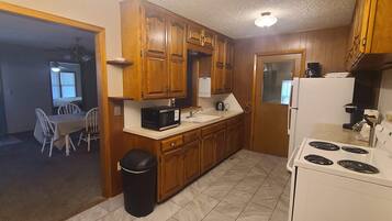 Fridge, microwave, coffee/tea maker, cookware/dishes/utensils