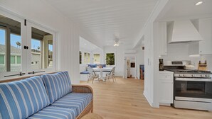 A spacious kitchen with white cabinetry and a large stove.