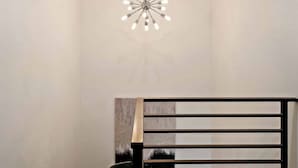 A modern staircase with a black handrail and a geometric wall design. - Sunrise Corner #43 BEAUTIFUL RENTAL, GREAT LOCATION! (Saint George)