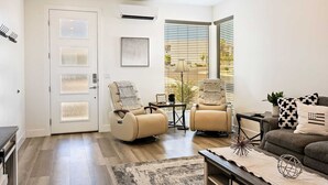 A modern living room with a beige sofa, two recliner chairs, a coffee table, and a side table with a lamp. - Sunrise Corner #43 BEAUTIFUL RENTAL, GREAT LOCATION! (Saint George)