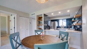 A modern kitchen with white cabinets, a built-in oven, and a large window. - Miracle's Runaway Bay 117 by SeaBreeze Vacation (Bradenton Beach)