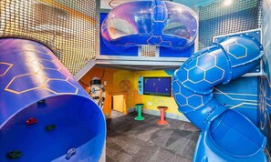 A children's play area with a large blue slide, a climbing wall, and a play structure resembling a space station. - Luxurious Mansion with Infinity Pool at Reunion (Kissimmee)