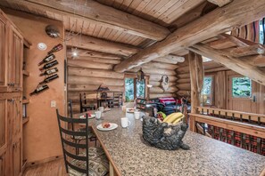Cozy dining area with a wooden ceiling, granite countertop, and comfortable seating options.