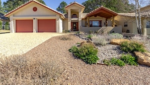 A two-story house with a red garage and a covered porch. - DB Mountain by Ruidoso Vacation Rentals (Ruidoso)