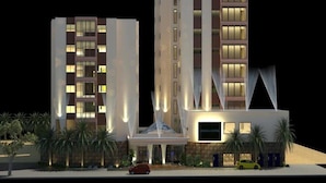 A modern hotel with a central atrium, multiple floors, and a distinctive facade. - Meshal Hotel And Spa (Manama)