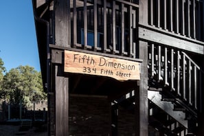 Experience the rustic charm of Fifth Dimension at 334 Fifth Street, featuring exposed beams and a cozy staircase.