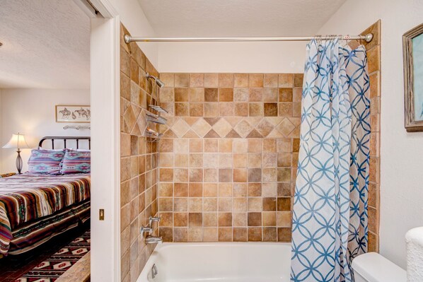 A bathroom with a shower, a bathtub, and a toilet. - Moonstar by Kokopelli Property Management (Santa Fe)