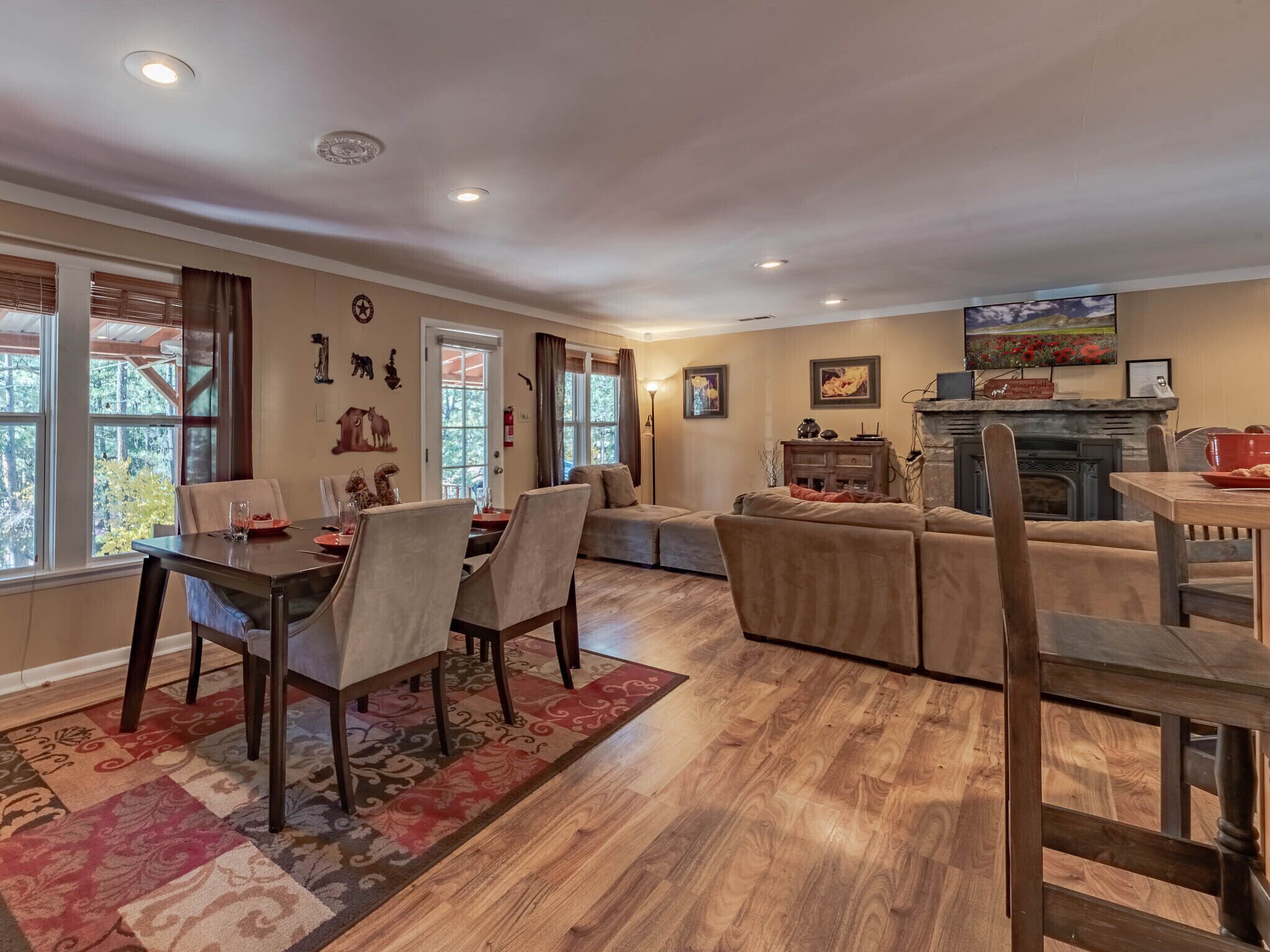 A spacious living room with a fireplace, a dining area, and a cozy seating arrangement.