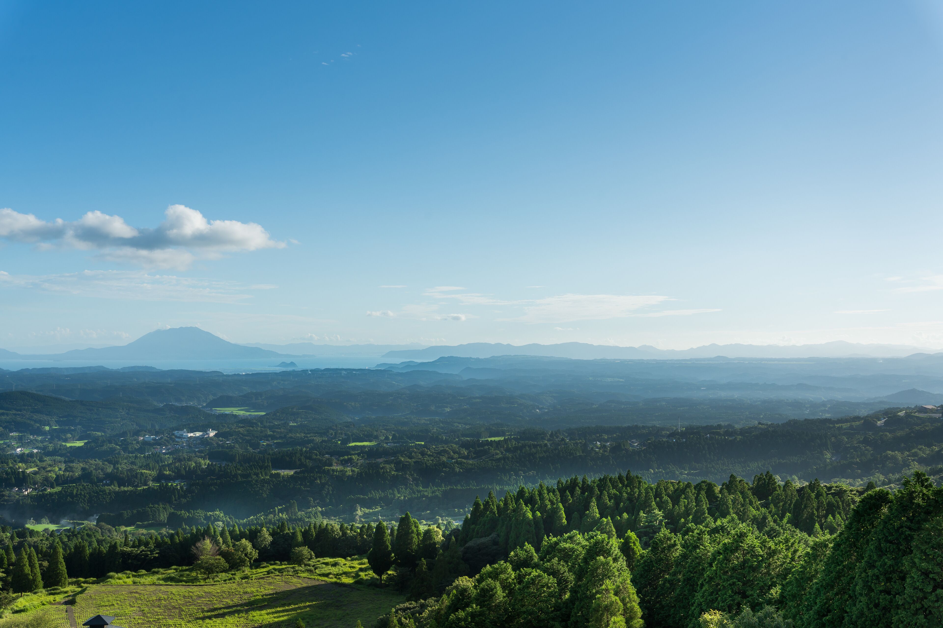 A panoramic view of a mountainous landscape with a clear sky.