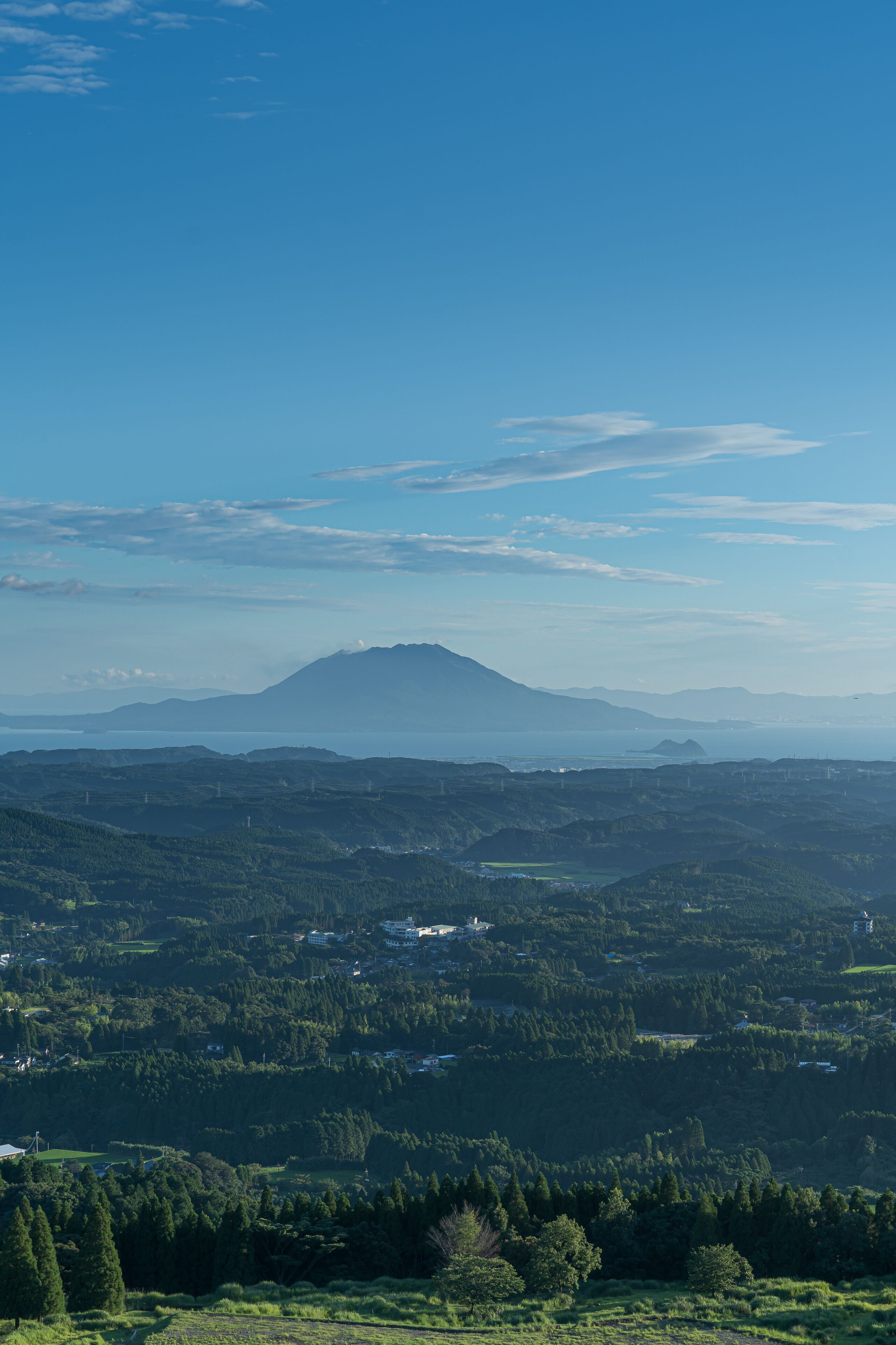 A panoramic view of a mountainous landscape with a clear sky.