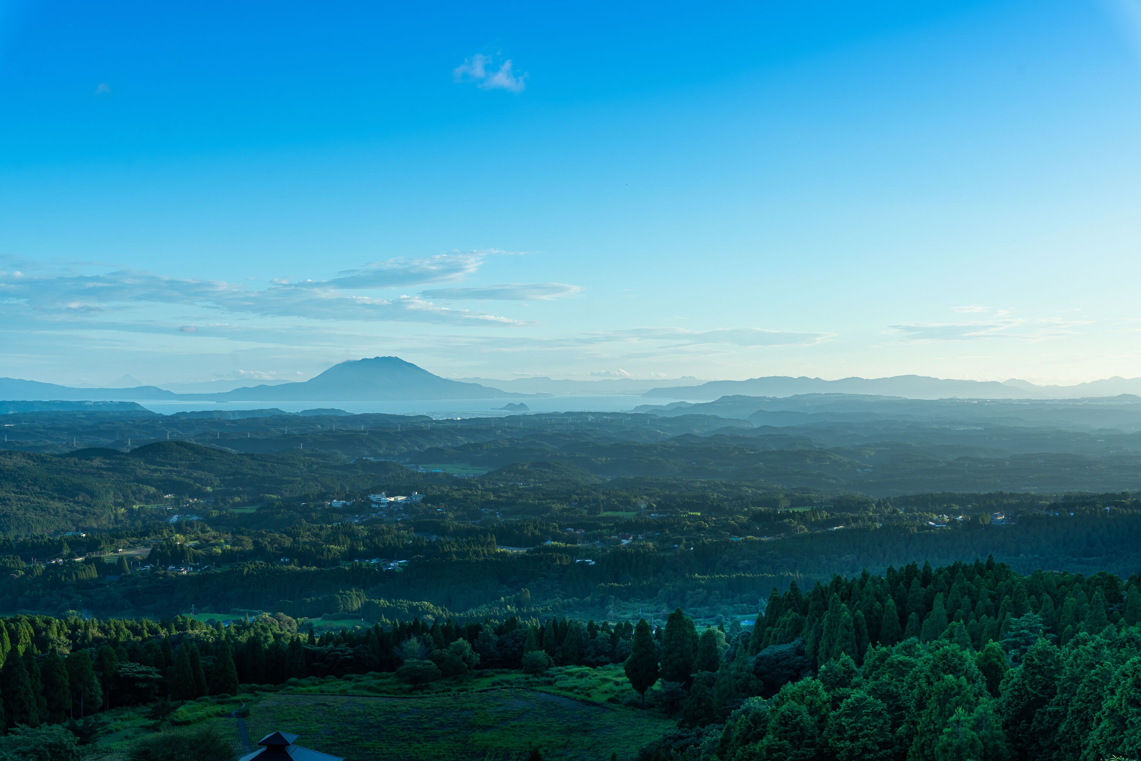 A panoramic view of a mountainous landscape with a clear sky.