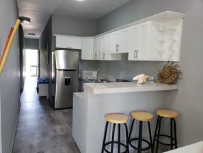 Fridge, microwave, stovetop, coffee/tea maker