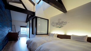 A modern bedroom with a large bed, wooden beams, and a view of the city. - Pres De La Mer (Hakodate)