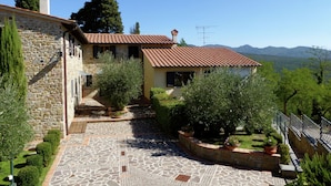 A stone house with a tiled roof, surrounded by greenery and a stone pathway. - Holiday Home in Montecarelli With Pool (Barberino di Mugello)