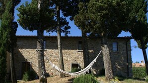 A stone building with a hammock in front. - Holiday Home in Montecarelli With Pool (Barberino di Mugello)