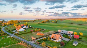 A rural landscape with houses, a road, and fields. - Cozy Studio 2 at the Seaside Agrotourism (Darlowo)
