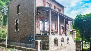 A historic brick building with a balcony and arched windows. - Splendid Villa in Vorsen (Gingelom)