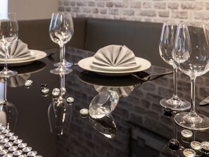 A dining table set with wine glasses, plates, and cutlery. - Flat in Elbingerode Near the Blue Lake-formerly TUI Ferienhaus (Oberharz am Brocken)