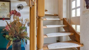 A wooden staircase with white steps and a wooden handrail. - Beautiful Apartment in Blankenburg With Sauna (Blankenburg)