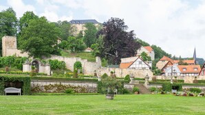 A historic town with stone walls, traditional houses, and a church. - Beautiful Apartment in Blankenburg With Sauna (Blankenburg)