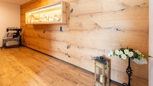 A wooden wall with a shelf displaying hats, a sewing machine, and a lantern with flowers. - Inviting Flat in Hart With Fitness Room (Hart im Zillertal)