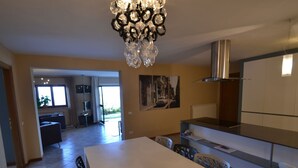 A modern kitchen with a white countertop, a yellow plate, and a chandelier. - Holiday Home in Pescia With Swimming Pool (Pescia)