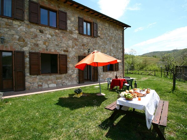 A stone building with a patio area.