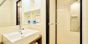 A modern bathroom with a large sink, mirror, and shower. - Rakuten STAY URBAN Shijo Teramachi (Kyoto)