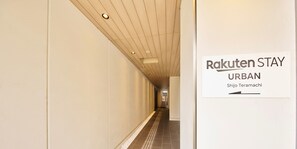 A hallway with a sign for 'Rakuten Stay Urban' at the end. - Rakuten STAY URBAN Shijo Teramachi (Kyoto)