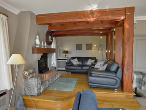 A living room with a fireplace, two sofas, a lamp, and a coffee table.