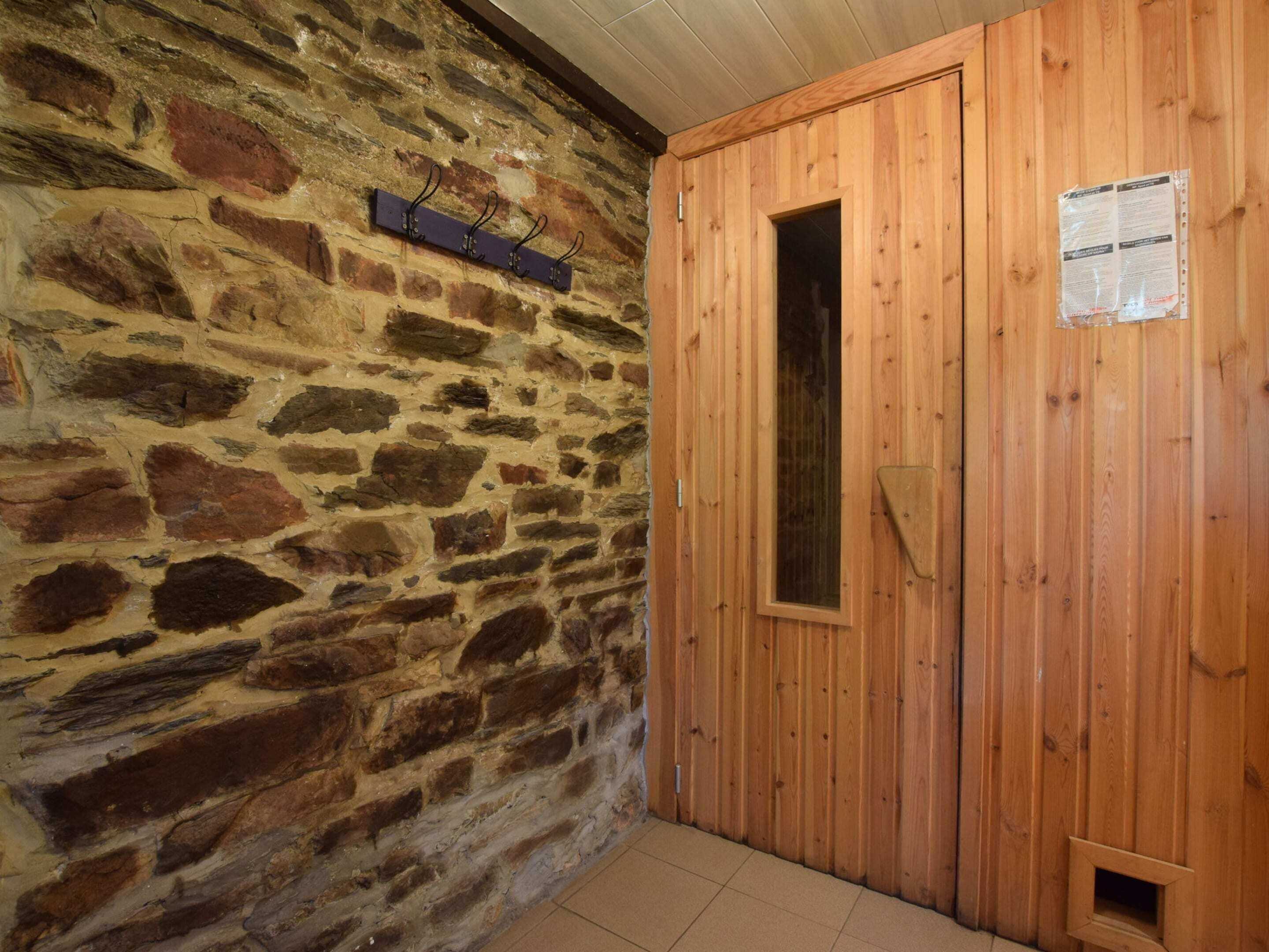 A stone wall with a wooden door and a small window.