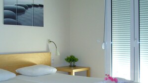 A hotel room with a bed, a bedside table, a lamp, and a wall-mounted picture. - Beautiful, Modern, Luxuriously Villa, Private Swimming Pool 8 p NW Coast, Crete (Rethymno)