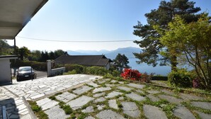 A stone-paved patio with a view of mountains and a lake. - Rustic Villa With Lake Views (Trarego Viggiona)