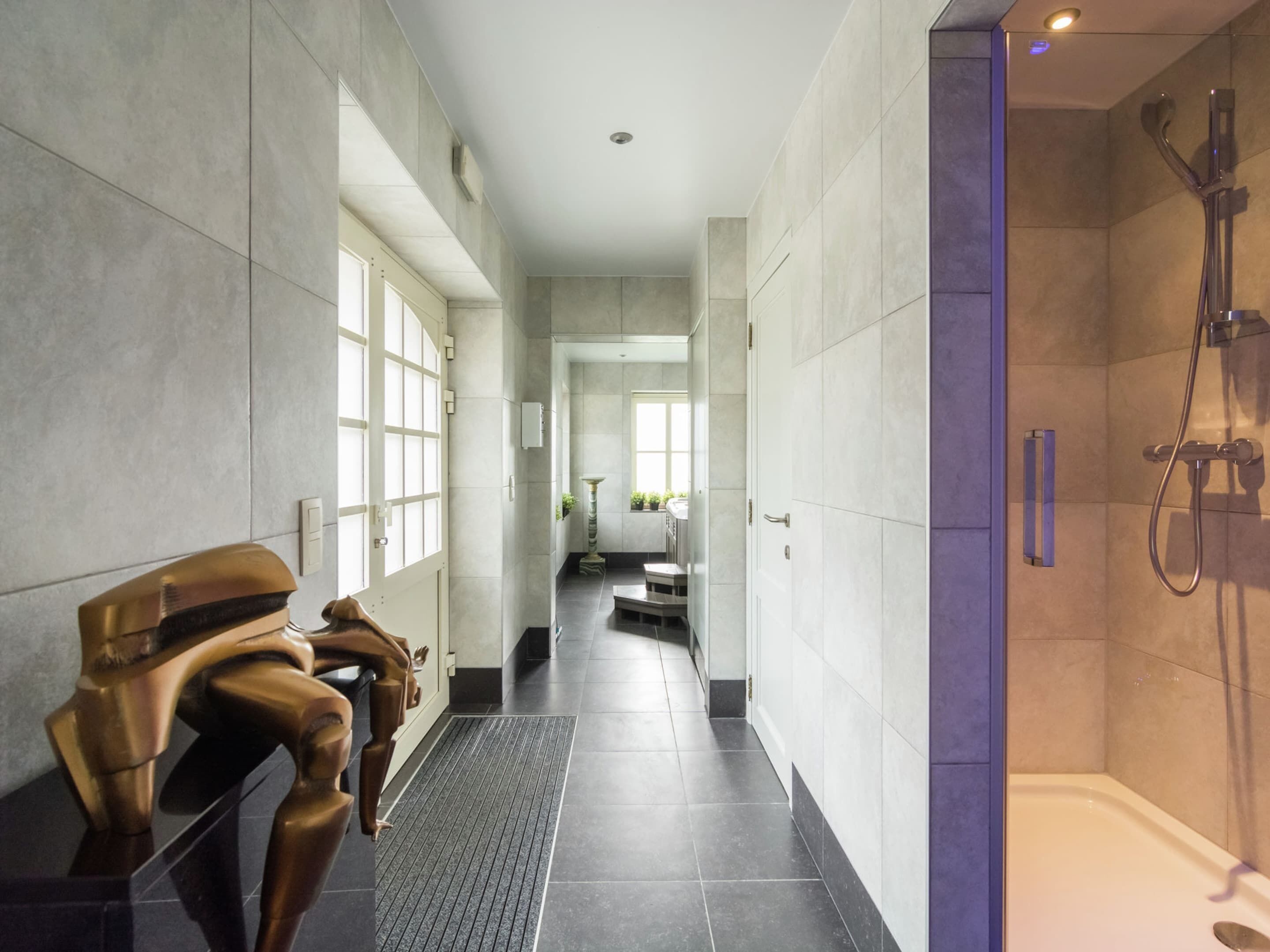 A modern bathroom with a walk-in shower, a bathtub, and a vanity area.