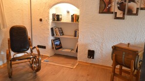 A room with a wooden chair, a bookshelf, and a small wooden cabinet. - Ruhlen: Schneifel Escape (Auw bei Prüm)