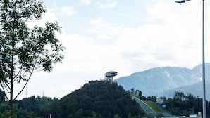 A residential area with modern buildings, a prominent tower, and a mountain backdrop. - Apartment Innsbruck near Bergisel Ski Jump (Innsbruck)