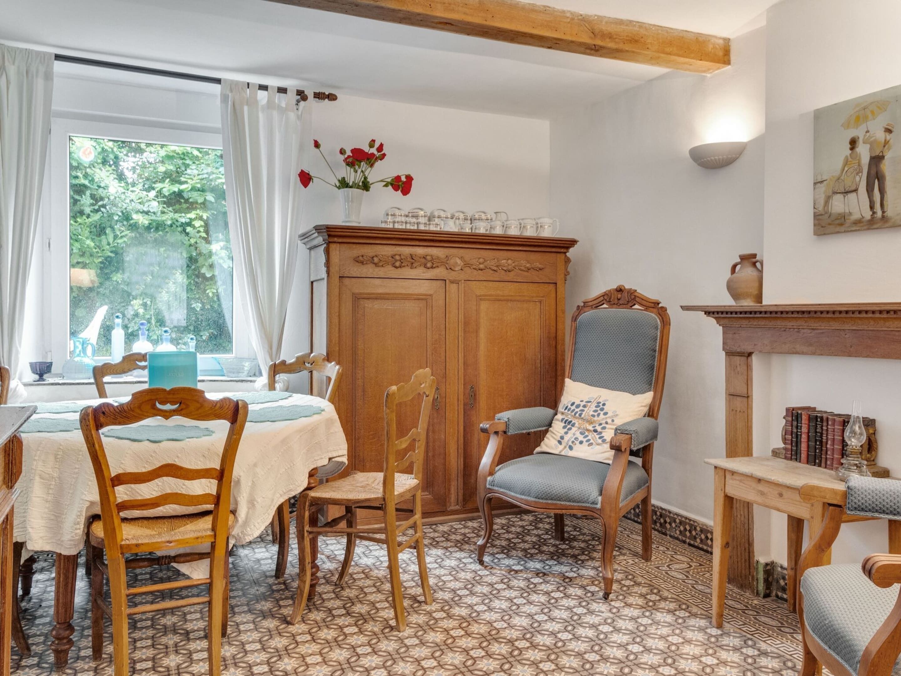 A dining area with a wooden table, chairs, and a cabinet.